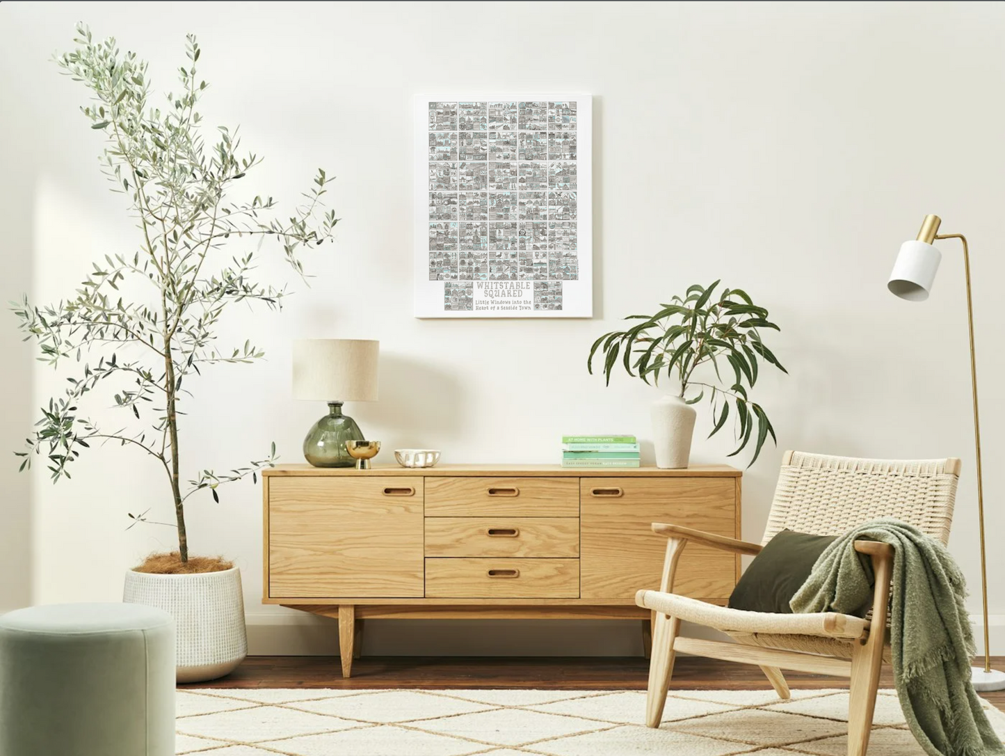 White framed A2 poster sized Whitstable Squared  print on living room wall with modern furniture and plants